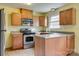 Eat-in kitchen with stainless steel appliances, light countertops, and wood cabinets at 409 Scaleybark Rd, Charlotte, NC 28209