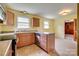 Kitchen featuring a peninsula, light countertops, and wood cabinets at 409 Scaleybark Rd, Charlotte, NC 28209