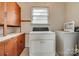 Laundry room featuring washer and dryer hookups, cabinets, and a window at 409 Scaleybark Rd, Charlotte, NC 28209