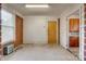 Mud room with brick accent wall, white walls, window, and an entrance to the kitchen at 409 Scaleybark Rd, Charlotte, NC 28209