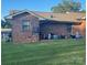 Brick home exterior featuring a well-maintained lawn and covered back porch, creating a cozy outdoor space at 441 Willow Spring Ln, Rock Hill, SC 29730