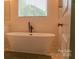 Close up of bathroom featuring freestanding tub, modern faucet, and neutral color scheme at 4710 Old Pageland Marshville Rd, Monroe, NC 28112