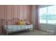 Comfortable bedroom featuring a daybed, pastel pink walls, and natural light at 4710 Old Pageland Marshville Rd, Monroe, NC 28112