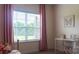 Bright bedroom with a desk and comfortable workspace, complemented by soft pink curtains at 4710 Old Pageland Marshville Rd, Monroe, NC 28112