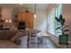 Bright and open dining area with large windows, a wooden table, a bench, and a seamless transition to the modern kitchen at 4710 Old Pageland Marshville Rd, Monroe, NC 28112