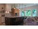 A modern kitchen with island seating, stainless appliances, pendant lighting, and a seamless transition to the living area at 4710 Old Pageland Marshville Rd, Monroe, NC 28112