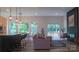 Bright open-concept living room and kitchen with wood floors, comfortable seating, large windows, and access to outdoor deck at 4710 Old Pageland Marshville Rd, Monroe, NC 28112