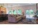 Cozy living room featuring wood floors, large windows with scenic views, and seamless connection to the kitchen and dining areas at 4710 Old Pageland Marshville Rd, Monroe, NC 28112