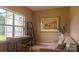 Home office with a desk, chair, sofa and large window creating a cozy work space at 4710 Old Pageland Marshville Rd, Monroe, NC 28112