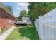 Home's fenced backyard features a small deck and shade trees at 500 Belleview Rd, Rock Hill, SC 29730