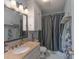 Well-lit bathroom features a single sink vanity with tan marble countertops, modern lighting, and toilet at 500 Belleview Rd, Rock Hill, SC 29730