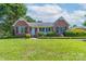 Charming brick home with a well-manicured lawn and inviting front porch and a red front door at 500 Belleview Rd, Rock Hill, SC 29730