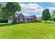 Attractive brick home featuring a manicured lawn, mature trees and a covered carport at 500 Belleview Rd, Rock Hill, SC 29730