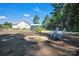 Backyard seating area with fire pit, shed, landscaping, and mature trees at 5016 Old Pine Ln, Cherryville, NC 28021