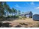 Spacious backyard with lush trees, patio, and shed perfect for outdoor living and enjoying nature at 5016 Old Pine Ln, Cherryville, NC 28021
