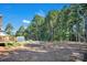 Vast backyard with mature trees, a small patio, and a shed that would make a peaceful retreat at 5016 Old Pine Ln, Cherryville, NC 28021