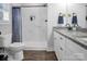 Modern bathroom featuring double granite vanity and walk-in shower with elegant marble tile at 5016 Old Pine Ln, Cherryville, NC 28021