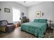 Bright bedroom featuring patterned bedding and a chair at 5016 Old Pine Ln, Cherryville, NC 28021
