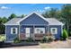 Charming blue home features a welcoming front porch, white trim, manicured landscaping, and a neatly kept yard at 5016 Old Pine Ln, Cherryville, NC 28021