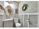 Charming bathroom with brick-style walls and decorative wreath at 504 Amon Ln, Pineville, NC 28134