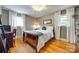 Bedroom with hardwood floors, natural light, and cozy decor at 504 Amon Ln, Pineville, NC 28134
