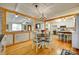 Open dining area featuring hardwood floors and seamless access to kitchen and living room at 504 Amon Ln, Pineville, NC 28134