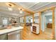 Open-concept kitchen with breakfast bar, hardwood floors, and seamless access to living areas at 504 Amon Ln, Pineville, NC 28134