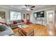 Comfortable living room featuring hardwood floors, large window, and stylish furnishings at 504 Amon Ln, Pineville, NC 28134