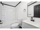 Bright, updated bathroom featuring a modern vanity and tiled shower-tub combination at 6085 Faith Rd, Salisbury, NC 28146