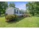 Well-maintained single-story home with light grey siding and a small deck at 6085 Faith Rd, Salisbury, NC 28146