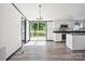 Bright kitchen with stainless appliances, granite countertops, island, and sliding glass doors to a deck at 6085 Faith Rd, Salisbury, NC 28146
