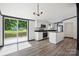 Bright kitchen with stainless appliances, granite countertops, island, and sliding glass doors to a deck at 6085 Faith Rd, Salisbury, NC 28146