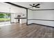 Bright open-concept living area with modern flooring and a view into the updated kitchen at 6085 Faith Rd, Salisbury, NC 28146