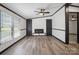Spacious living room with a ceiling fan, dark trim, and an electric fireplace at 6085 Faith Rd, Salisbury, NC 28146