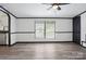 Bright, freshly painted living room with contemporary flooring and ceiling fan at 6085 Faith Rd, Salisbury, NC 28146