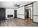 Bright living room featuring modern flooring, a ceiling fan, and a cozy fireplace at 6085 Faith Rd, Salisbury, NC 28146