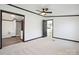 Bright primary bedroom showcasing plush carpets and an entrance to the en-suite bathroom at 6085 Faith Rd, Salisbury, NC 28146