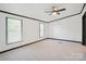Spacious main bedroom featuring plush carpeting, natural lighting, and a ceiling fan at 6085 Faith Rd, Salisbury, NC 28146
