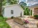 Lush backyard featuring green grass, shade trees, patio and detached garage at 6116 Springhouse Ln, Charlotte, NC 28211