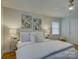 Bright bedroom features neutral walls, refinished hardwood floors and contemporary decor at 6116 Springhouse Ln, Charlotte, NC 28211