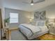 Cozy bedroom featuring a ceiling fan, neutral walls, and refinished hardwood floors at 6116 Springhouse Ln, Charlotte, NC 28211