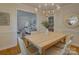 Dining area with a large table, modern light fixture, and an open view to the cozy living room at 6116 Springhouse Ln, Charlotte, NC 28211