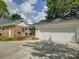Charming brick home with detached garage, lush landscaping and inviting walkway at 6116 Springhouse Ln, Charlotte, NC 28211