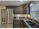 Kitchen featuring granite countertops, stainless steel appliances, dark wood cabinets and a stainless refrigerator at 6116 Springhouse Ln, Charlotte, NC 28211
