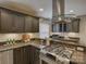 Updated kitchen with granite countertops, stainless steel appliances, dark wood cabinets and modern range hood at 6116 Springhouse Ln, Charlotte, NC 28211