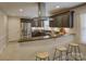 Stylish kitchen featuring dark cabinets, stainless steel appliances, granite countertops, and a breakfast bar at 6116 Springhouse Ln, Charlotte, NC 28211