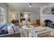 Inviting living room featuring hardwood floors, a fireplace, comfortable seating, and an open layout with kitchen access at 6116 Springhouse Ln, Charlotte, NC 28211