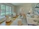 Inviting living room showcasing ample natural light, hardwood floors, and a view to the dining area at 6116 Springhouse Ln, Charlotte, NC 28211