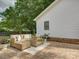Inviting patio featuring wicker furniture, brick pavers and shade trees at 6116 Springhouse Ln, Charlotte, NC 28211