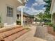 Covered patio featuring brick steps, outdoor seating and view of the brick home at 6116 Springhouse Ln, Charlotte, NC 28211
